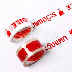 เทปพิมพ์ลาย ระวังแตก Fragile Tape 2 นิ้ว x 50 หลา (พื้นใส ตัวอักษรสีแดง)